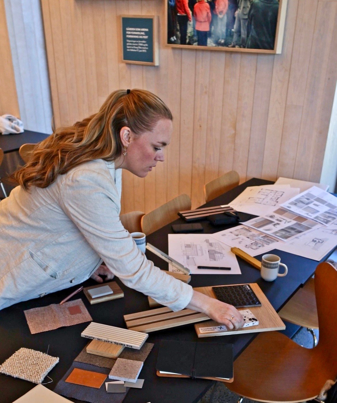 Portrait of architect and interior designer Lene Moen Grannes at her work desk.