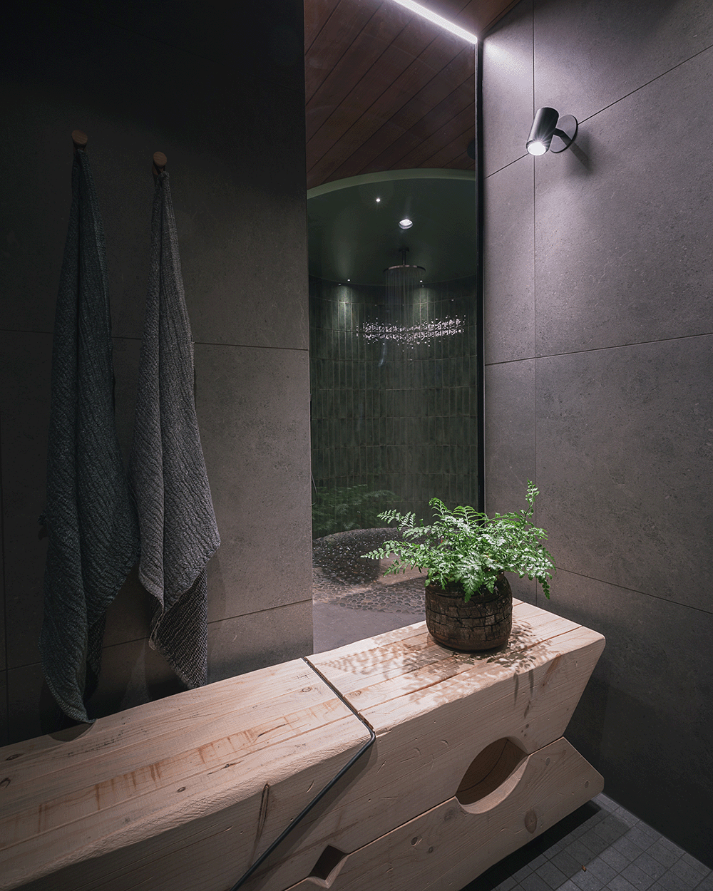 Curved glass shower wall and oversized clothespin bench in a fantasy-themed bathroom.